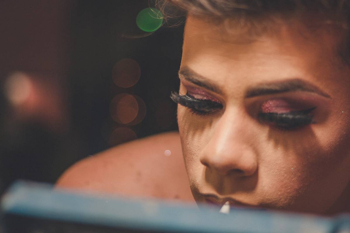 Close-up of dramatic performance art makeup showing textured cheekbones and expressive eye detailing