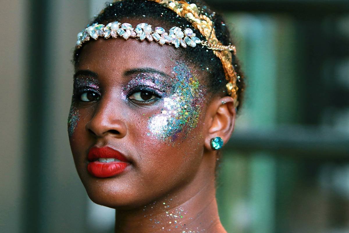 Dancer applying dance performance makeup with bold contouring under bright vanity lights